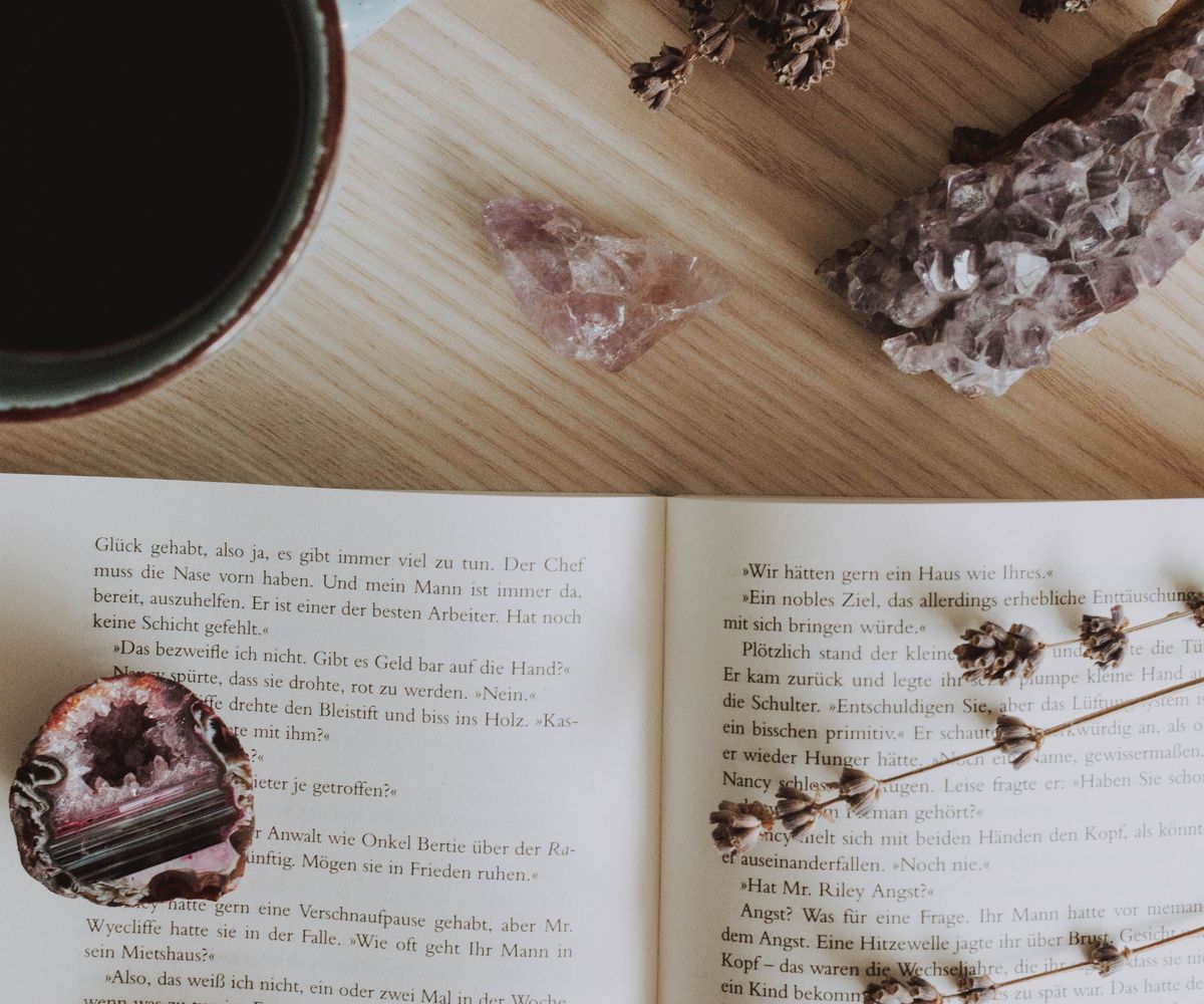 A journal, pen and candle in warm light