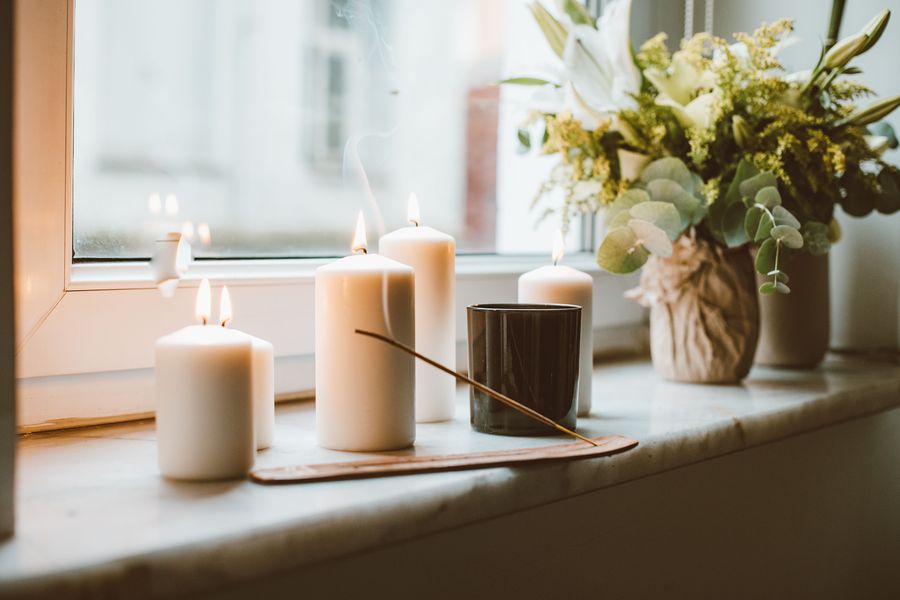 Candles and eucalyptus on a sunlit windowsill